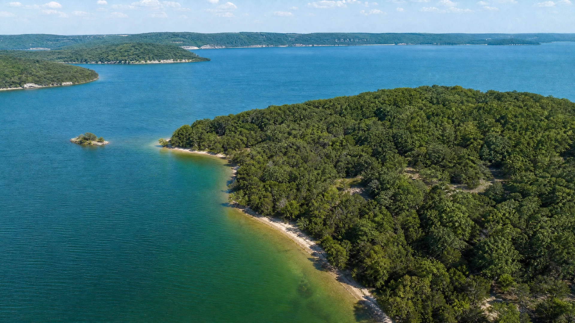 Illustrative elevated view of a Lake Texoma cove with wooded shoreline